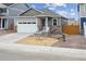 Charming single-story home with gray siding, stone accents, and a two-car garage at 6500 13Th St, Frederick, CO 80530