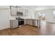 Stylish kitchen with stainless steel appliances, a corner layout and wood grain floors at 6500 13Th St, Frederick, CO 80530