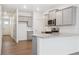 Modern kitchen features gray cabinets, stainless appliances, granite countertops, and an island at 6500 13Th St, Frederick, CO 80530