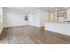 Spacious living room with hardwood flooring, open concept, and flows into kitchen area at 6500 13Th St, Frederick, CO 80530