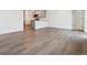 Open concept living space with wood grain floors leading into the kitchen and dining area at 6500 13Th St, Frederick, CO 80530