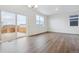 Bright living room boasts hardwood floors and a sliding glass door to access outdoor living space at 6500 13Th St, Frederick, CO 80530