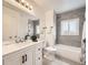 Modern bathroom with stylish vanity, mirror, and shower/tub with tiled walls at 11062 Hudson Ct, Thornton, CO 80233