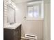 Bathroom featuring updated vanity, mirror, and window at 11062 Hudson Ct, Thornton, CO 80233