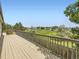 Wooden deck overlooking a lush green landscape, providing an ideal setting for outdoor enjoyment and scenic views at 11062 Hudson Ct, Thornton, CO 80233
