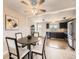Bright dining area with modern lighting fixture next to a modern kitchen with stainless appliances at 11062 Hudson Ct, Thornton, CO 80233