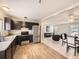 Open-concept kitchen and living area with stainless steel appliances and bright lighting at 11062 Hudson Ct, Thornton, CO 80233