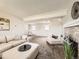 Spacious living room showcasing carpeted floors, modern furniture, and a brick fireplace at 11062 Hudson Ct, Thornton, CO 80233