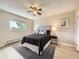 Stylish main bedroom with a comfortable bed, modern ceiling fan, and ample natural light creating a serene retreat at 11062 Hudson Ct, Thornton, CO 80233