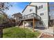 A two-story home featuring a deck and a backyard with green grass, patio, and stairs to the upper deck at 8414 Bed Straw St, Parker, CO 80134