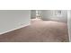 Finished basement with sliding glass doors and carpet flooring at 8414 Bed Straw St, Parker, CO 80134