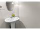 Powder room boasts pedestal sink, decorative mirror, and modern fixtures at 8414 Bed Straw St, Parker, CO 80134
