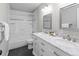Bathroom features double sink vanity with framed mirror and tiled shower/tub at 8414 Bed Straw St, Parker, CO 80134
