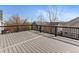A large deck features gray decking and black railings, providing ample outdoor space with neighborhood views at 8414 Bed Straw St, Parker, CO 80134