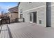 A well-maintained deck outside of a home features gray decking, black railing, and a sliding glass door entry at 8414 Bed Straw St, Parker, CO 80134