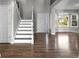 Inviting entryway featuring a staircase with wood floors and a view into the living space at 8414 Bed Straw St, Parker, CO 80134