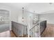 Upstairs hallway with decorative railing and views of the living areas below at 8414 Bed Straw St, Parker, CO 80134