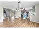 Wide view of an open floor plan with a staircase, living room, and a modern kitchen with a center island at 8414 Bed Straw St, Parker, CO 80134