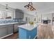 Modern kitchen with stainless steel appliances, gray cabinets, blue backsplash, and a center island at 8414 Bed Straw St, Parker, CO 80134
