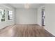 Bright and spacious living room with wood floors, large windows and elegant lighting at 8414 Bed Straw St, Parker, CO 80134