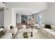 Open-concept living area showcasing hardwood floors, modern furniture, and a view of the dining area and kitchen at 8414 Bed Straw St, Parker, CO 80134