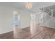 Open-concept view of the home featuring the staircase, living room, and kitchen with light colored floors at 8414 Bed Straw St, Parker, CO 80134
