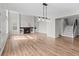 Living room featuring a fireplace and stairs to the upper level, with wood floors at 8414 Bed Straw St, Parker, CO 80134