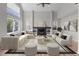 Bright living room with vaulted ceilings, a modern fireplace, large windows, and contemporary furnishings at 8414 Bed Straw St, Parker, CO 80134