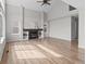 Living room with a fireplace, built-in shelves, wood flooring, and plenty of space at 8414 Bed Straw St, Parker, CO 80134