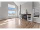 Living room featuring a fireplace, built-in shelving, large windows, and wood flooring at 8414 Bed Straw St, Parker, CO 80134