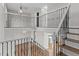 Staircase with decorative railings and wooden steps, overlooking the living area and kitchen at 8414 Bed Straw St, Parker, CO 80134