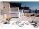 Charming backyard patio with white furniture, ideal for outdoor dining and entertaining at 3746 Jason St, Denver, CO 80211