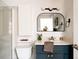 Stylish bathroom with modern vanity, black framed mirror, and updated fixtures at 3746 Jason St, Denver, CO 80211