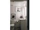 Cozy bathroom featuring a decorative mirror, modern sink, and charming mosaic tile flooring at 3746 Jason St, Denver, CO 80211