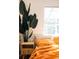 Cozy bedroom with bright accents, stylish nightstand, and sun-filled window at 3746 Jason St, Denver, CO 80211