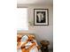 Bright bedroom featuring window, plant, and striking black and white artwork at 3746 Jason St, Denver, CO 80211