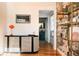 Hallway featuring a modern cabinet, decor, and a view to an updated bathroom at 3746 Jason St, Denver, CO 80211