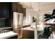 Contemporary kitchen with a large island, stainless steel appliances, and stylish pendant lights at 3746 Jason St, Denver, CO 80211