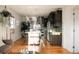 Open concept kitchen featuring stainless appliances, dark cabinets, and hardwood floors at 3746 Jason St, Denver, CO 80211