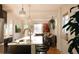 Bright, open kitchen connected to a living area with modern appliances and sleek countertops at 3746 Jason St, Denver, CO 80211