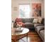 Stylish living room featuring a comfortable sofa, hardwood floors, and natural lighting at 3746 Jason St, Denver, CO 80211