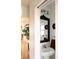 Well-lit powder room with decorative mirror, vintage decor, and pedestal sink at 3746 Jason St, Denver, CO 80211