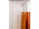 Clean shower space featuring white subway tile and orange curtain at 3746 Jason St, Denver, CO 80211