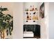 Charming wet bar with open shelving, sink, tiled backsplash, and elegant fixtures at 3746 Jason St, Denver, CO 80211