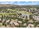 Aerial view of house surrounded by golf course, pond and trees at 3228 Country Club Pkwy, Castle Rock, CO 80108