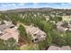 Aerial view of home nestled in a wooded neighborhood with a golf course nearby at 3228 Country Club Pkwy, Castle Rock, CO 80108