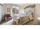 Charming bedroom with a cozy armchair and a large window allowing natural light to fill the room at 3228 Country Club Pkwy, Castle Rock, CO 80108