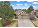 Exterior elevation features two-car garage, stone accents, and concrete driveway at 3228 Country Club Pkwy, Castle Rock, CO 80108