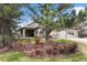 Beautiful ranch-style home with stone accents, attached garage, and well-manicured front yard with mature trees at 3228 Country Club Pkwy, Castle Rock, CO 80108