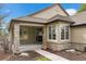 Inviting covered front porch with stone pillars and a stylish front door with sidelights and transom window at 3228 Country Club Pkwy, Castle Rock, CO 80108